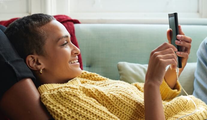Lady lying on couch looking at phone